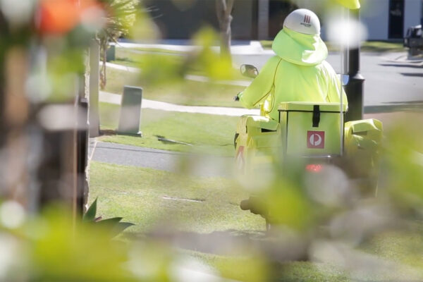 Auspost delivery driver on a motorbike.