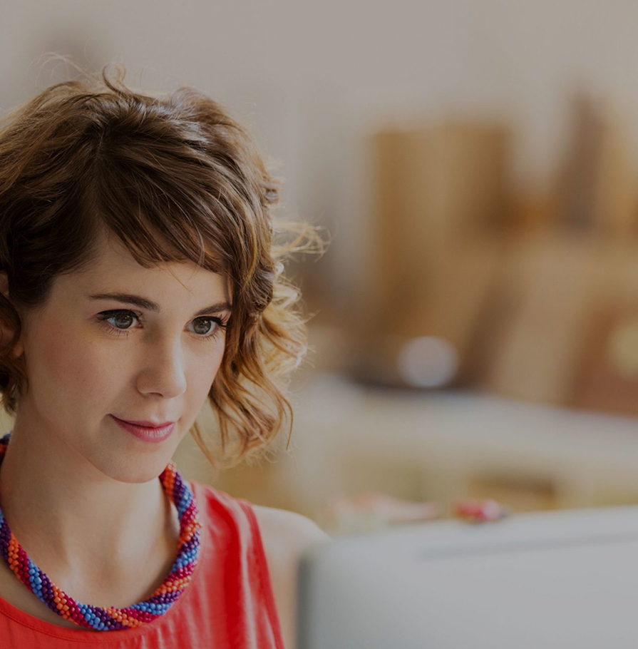 A woman looking at a computer screen.