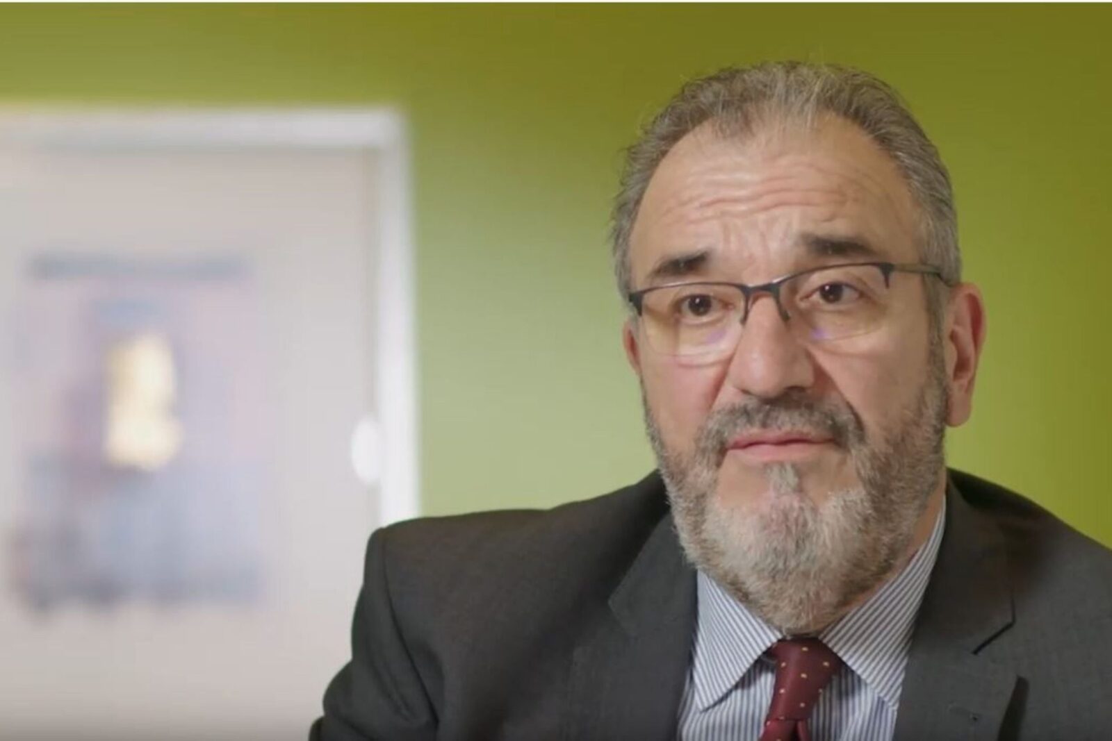 Close-up of a man in a suit and tie.